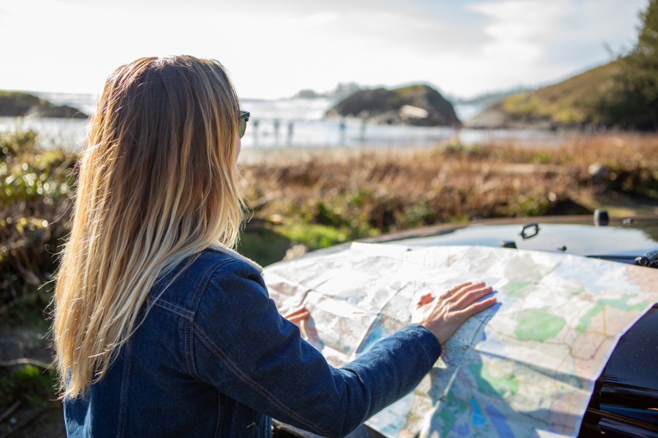 Photo: Woman with a geography map
